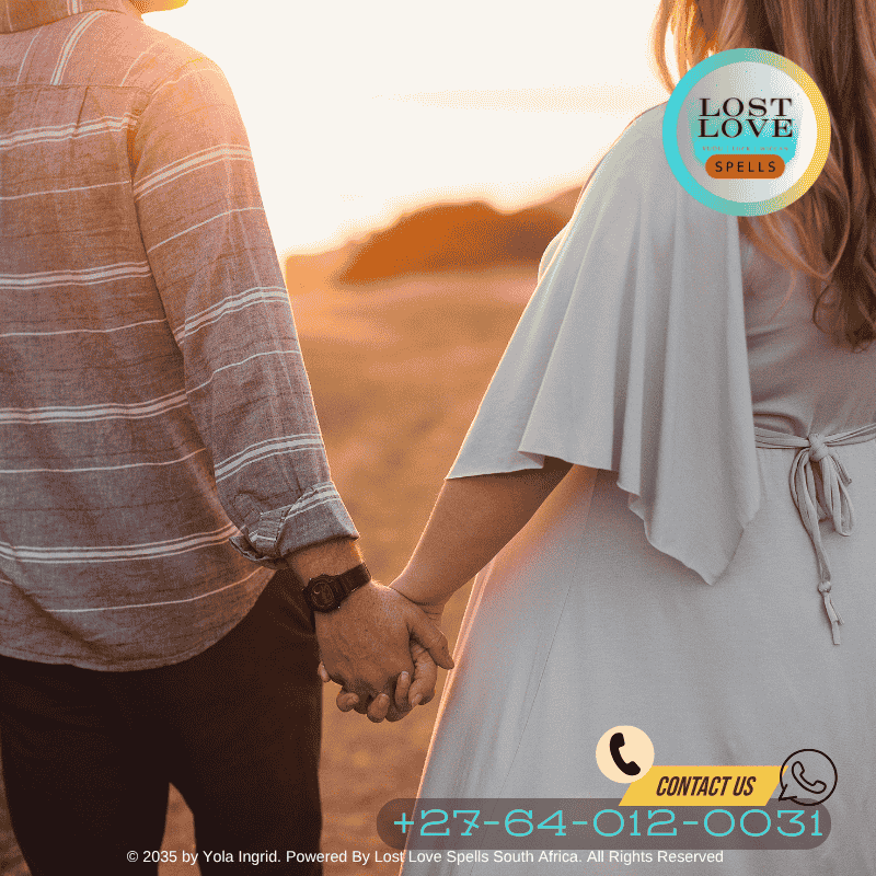 A couple holding hands at sunset, reunited and smiling after a lost love spell worked.