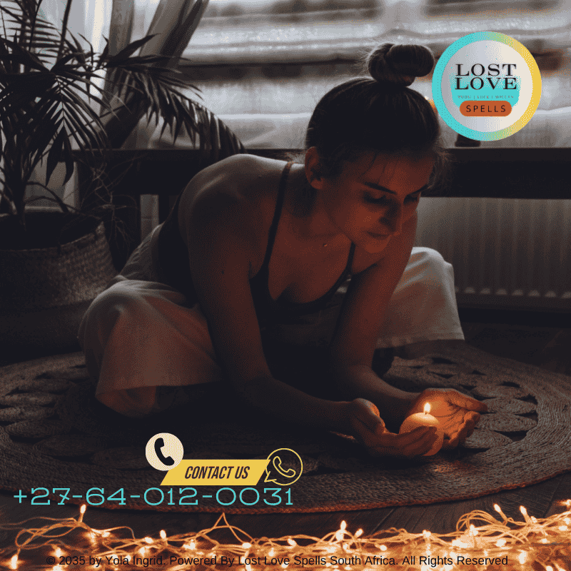 A person performing a lost love spell with candles and personal items.