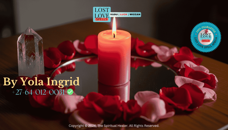 A pink candle burning before a mirror with rose petals and a crystal for a love attraction ritual.