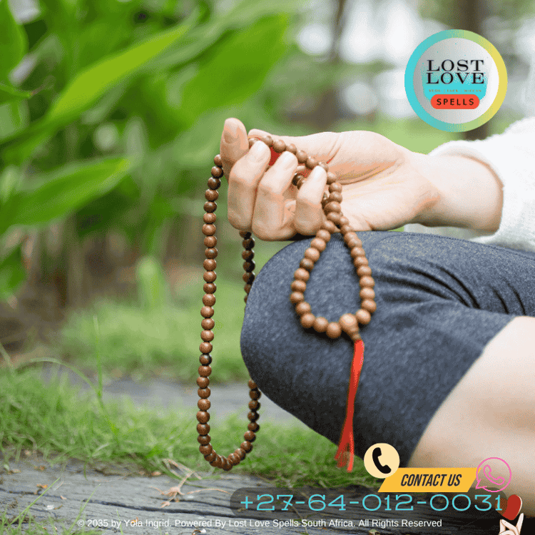 Close-up of hands holding rose quartz and tribal bead talisman