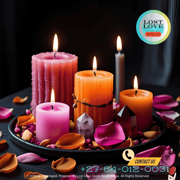 Pink and orange candles surrounded by rose petals and carnelian crystal