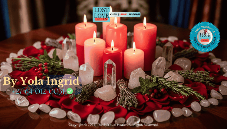 Pink and red candles surrounded by rose petals, crystals, and herbs used in love magic ritual.