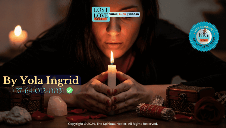 Woman focusing on a candle flame while setting her intention during a love spell ritual.